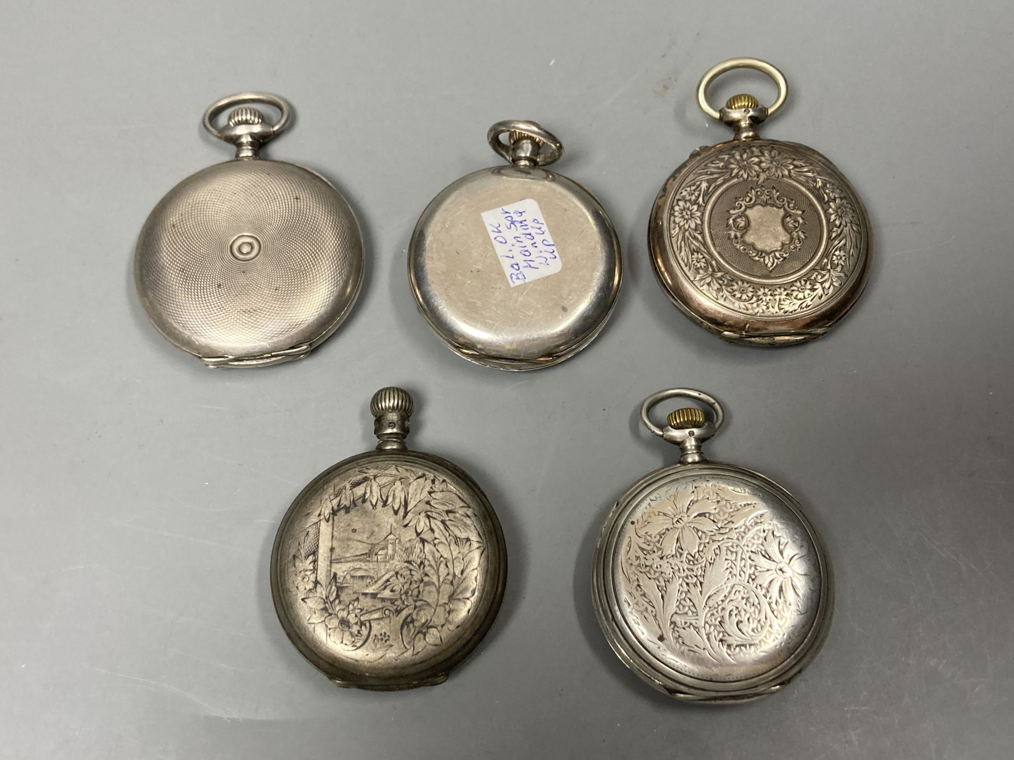 Five assorted early 20th century white metal pocket watches including three Longines (a.f.).